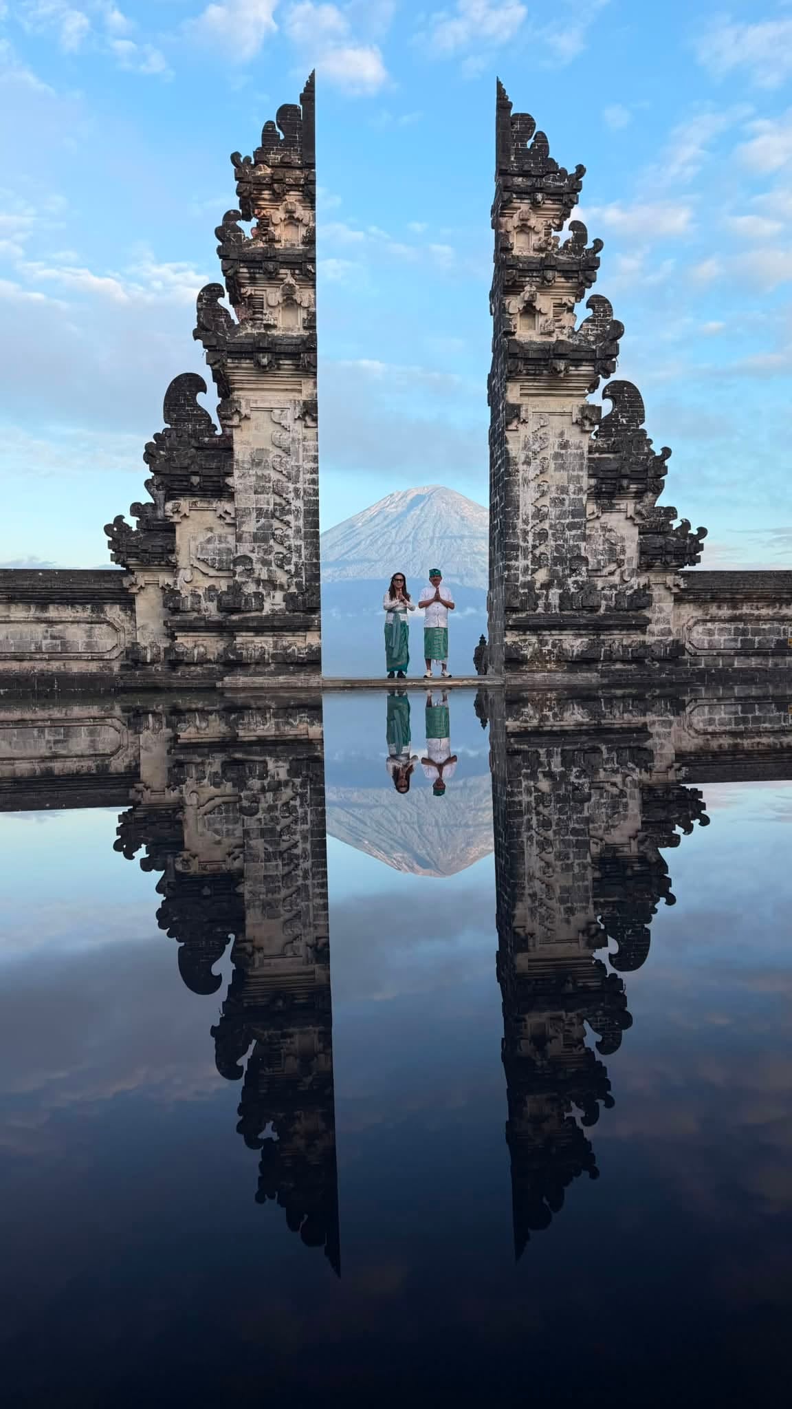 Couple in traditional attire at Lempuyang Gates of Heaven with Mount Agung
